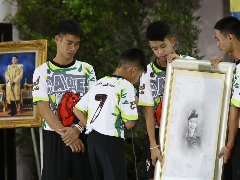 Photo of the day: Twelve Thai boys and their soccer coach, who were rescued from a flooded cave, paying their respects to fallen Navy Seal Saman Kunan at a news conference in the northern province of Chiang Rai, Thailand on Wednesday (July 18).