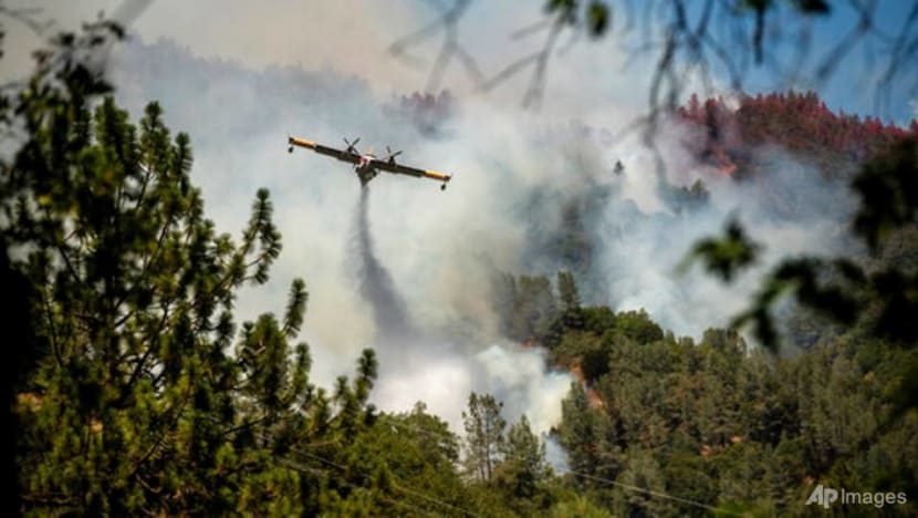 California firefighters battle big wildfires in high heat