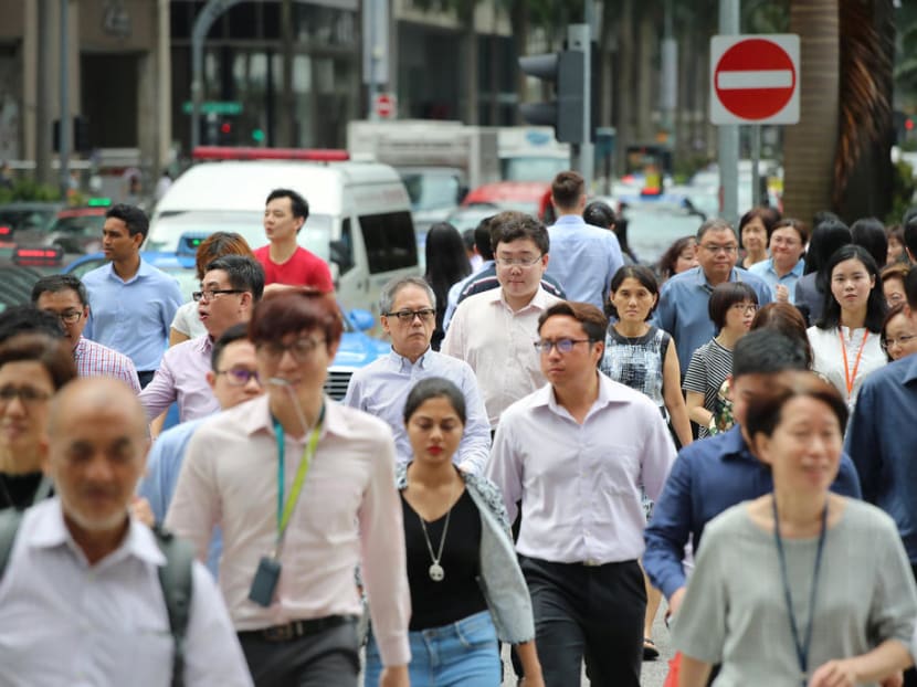 People crossing a street in Singapore's central business district.