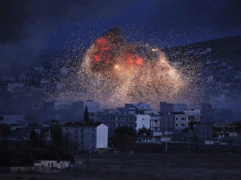 Flames erupt after an air strike in October by the United States-led coalition in Kobani, Syria. The international coalition with 4,500 troops has launched more than 1,000 air strikes on Islamic State positions. Photo: AP