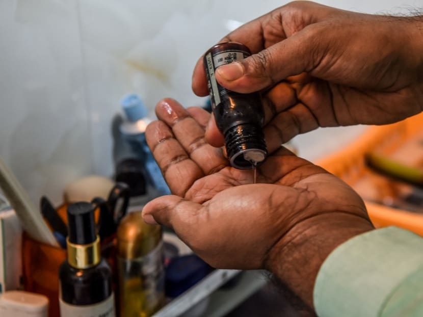30-year-old communications executive Suraj Balakrishnan prepares to massage his beard with oil at his home in Mumbai.