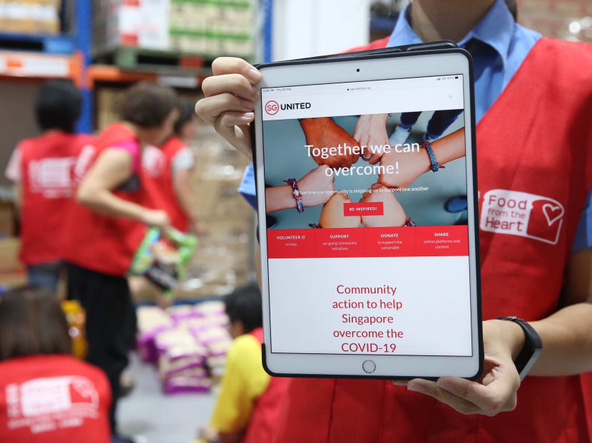 A volunteer holding up a tablet during the Feb 20 2020 launch of SG United Portal for Singaporeans looking for an avenue to contribute to the national response to Covid-19.