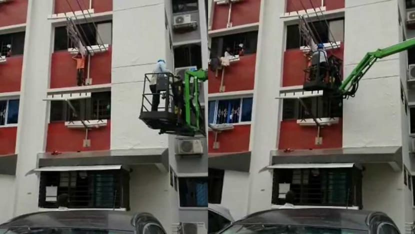 Child standing on window ledge of HDB flat in Hougang rescued by worker