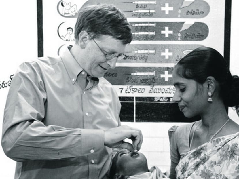 Mr Bill Gates giving a baby an oral polio drop in Andhra Paradesh, India, where the Bill and Melinda Gates foundation is on a mission to eradicate polio. REUTERS