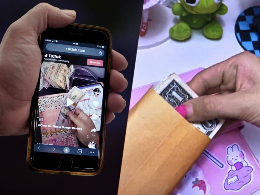 A video screenshot showing the “cash stuffing” TikTok trend, where people put cash in envelopes as a budgeting method.
