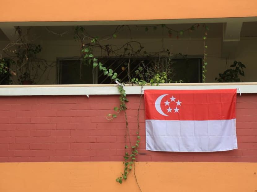 Singapore flag hanging on a HDB block. TODAY file photo