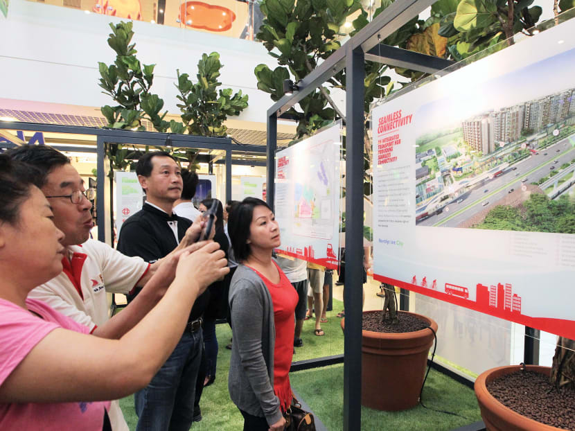 Visitors taking photographs at the Northpoint City Exhibition yesterday. Photo: OOI BOON KEONG