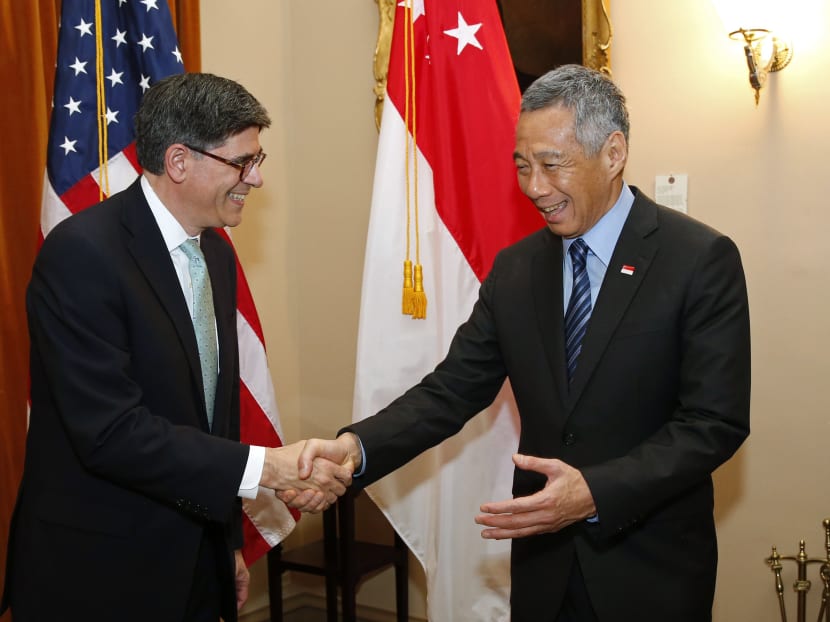 US Treasury Secretary Jack Lew (left) shakes hands with Singapore's Prime Minister Lee Hsien Loong at the Treasury Department in Washington June 23, 2014. Photo: Reuters