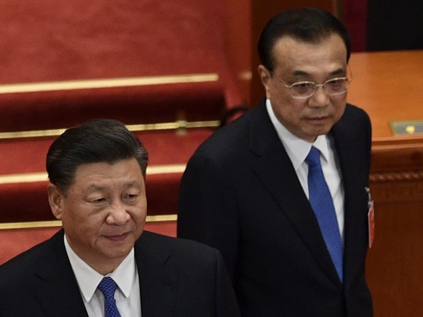 Chinese President Xi Jinping (left) and Premier Li Keqiang arrive for the the closing session of the National People's Congress at the Great Hall of the People in Beijing on May 28, 2020.