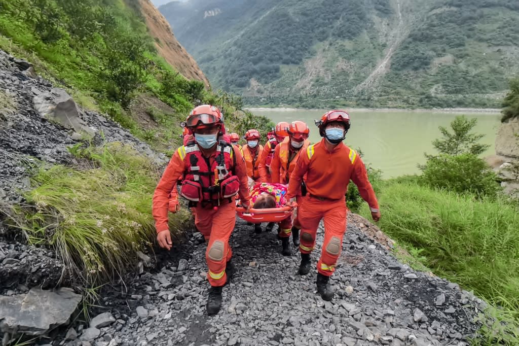 Rescue workers carry an injured person after a 6.6-magnitude earthquake in Luding county, Ganzi Prefecture in China's southwestern Sichuan province on Sept 6, 2022.