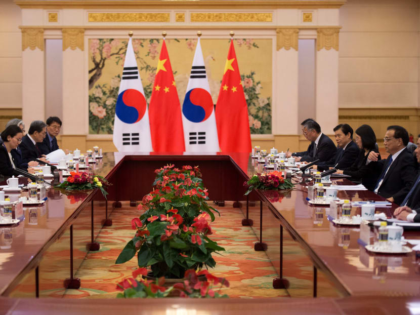 South Korea's President Moon Jae-In (2nd L) talks with China's Premier Li Keqiang (2nd R) in Beijing on Dec 15. While experts said Mr Moon’s visit to Beijing could be a good start in repairing ties strained by the Thaad dispute they also agreed that it needed time and patience before the wounds could be fully healed and trust rebuilt. Photo: Reuters