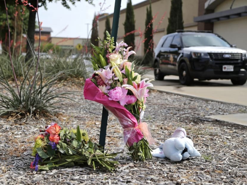 Flowers and a stuffed animal are left at the scene the day after a shooting at Allen Premium Outlets on May 7, 2023 in Allen, Texas. 