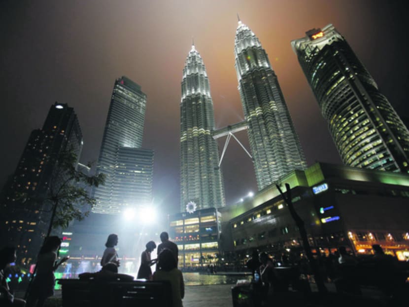 Tourists gather near the foot of the Petronas Twin Towers in Kuala Lumpur. Reuters file photo