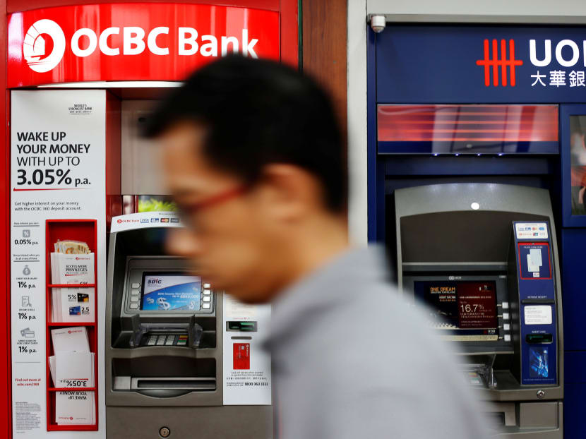 A man walking past OCBC and UOB automated bank tellers. Reuters file photo