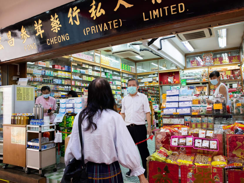 A customer talking to the shop owner of Fong Cheong Medical Hall at Hong Lim Complex in Chinatown on May 5, 2020.