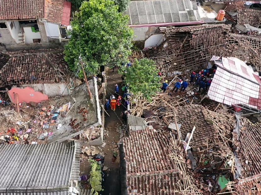 An aerial view shows rescue personnel working to rescue a child from the rubble of a collapsed house at Cugenang in Cianjur, West Java following a 5.6-magnitude earthquake on Nov 21. 

