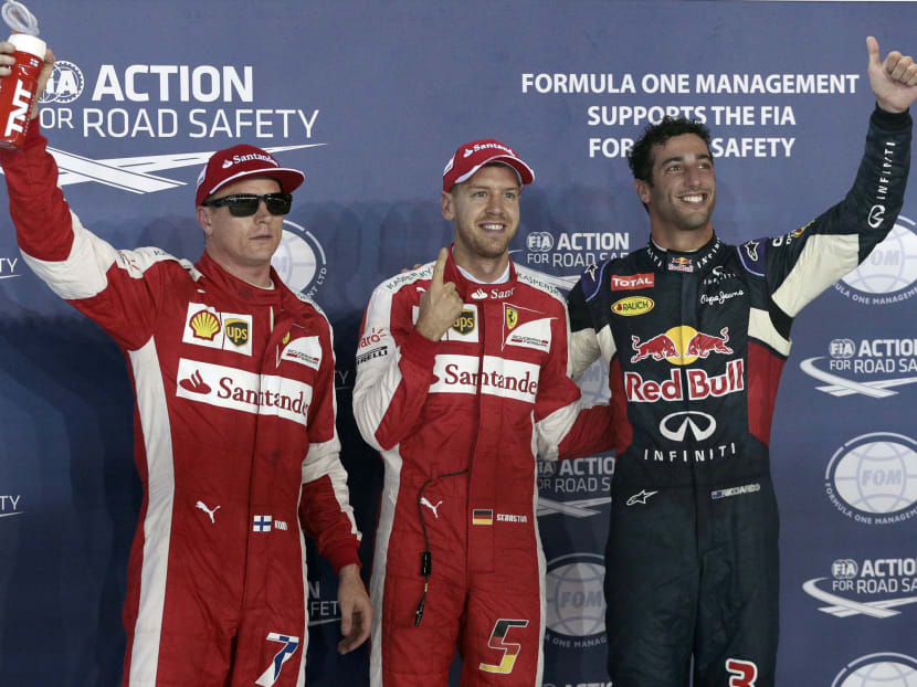 Sebastian Vettel of Germany (centre) celebrating claiming pole at the Singapore GP. Daniel Ricciardo (right) got P2, while Vettel's Ferrari teammate Kimi Raikkonen clinched P3. Photo: Jason Quah/TODAY