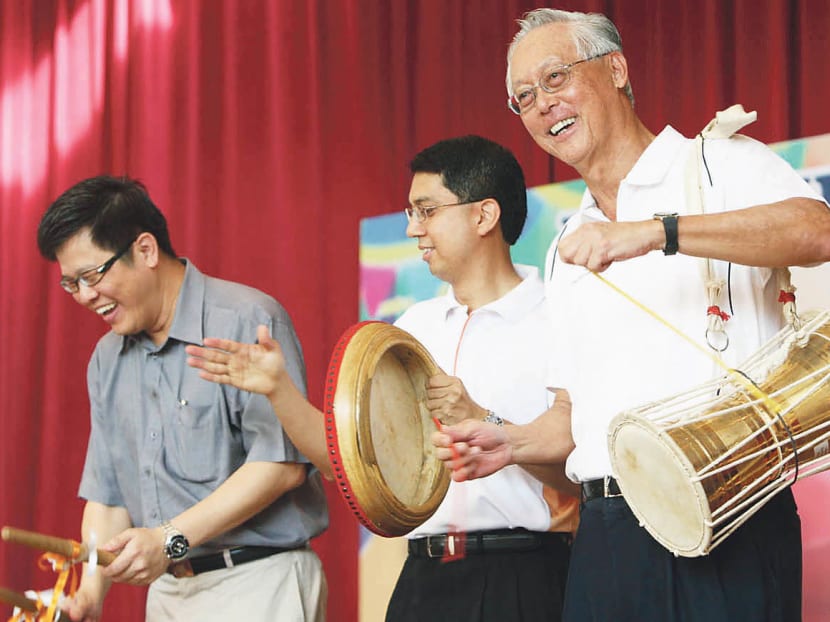 A file photo of Senior Minister Goh Chok Tong in July 2009, playing a traditional dhol drum with other Members of Parliament of Marine Parade constituency.