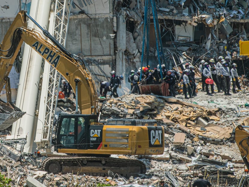 Search and Rescue teams look for possible survivors in the partially collapsed 12-story Champlain Towers South condo building in Surfside, Florida, US on June 27, 2021.