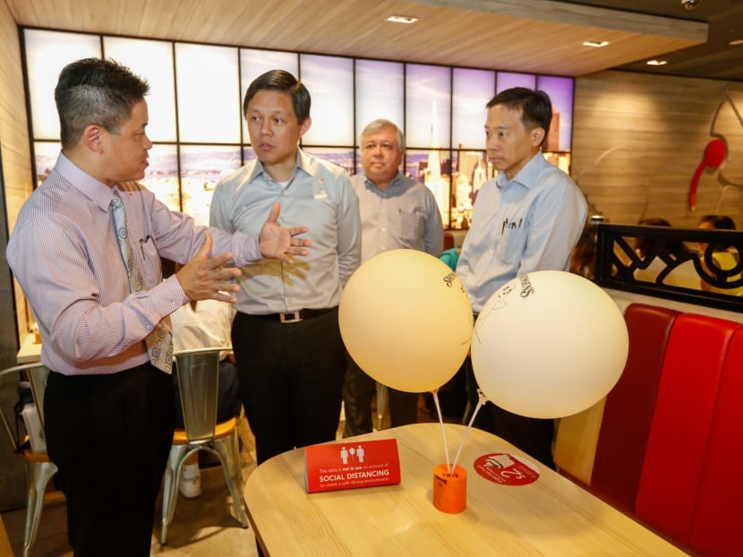 Trade and Industry Minister Chan Chun Sing (second from left) at a visit to Swensens' restaurant in Bugis Junction mall on March 31, 2020.