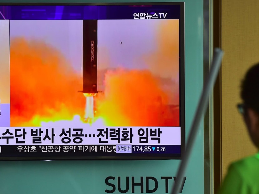 A man walks past a television screen reporting news of North Korea's Musudan missile test in June. Photo: AFP
