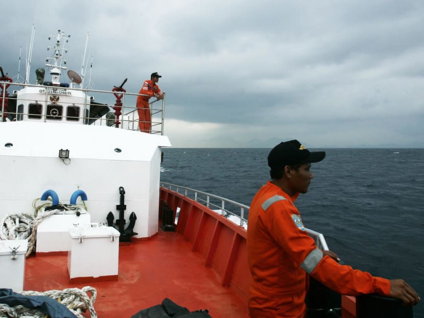 Members of a rescue team stand on the deck of a Basarnas rescue ship during a search and rescue operation to find the missing Malaysia Airlines flight MH370, in the Andaman Sea, March 15, 2014. Photo: Reuters