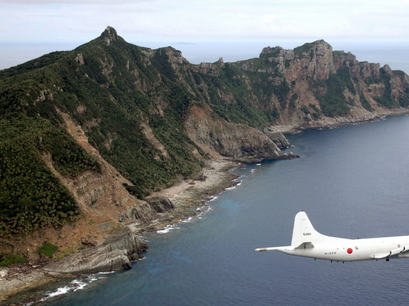In this file picture, a Japanese surveillance plane flying over the disputed islands in the East China Sea. Photo: Reuters