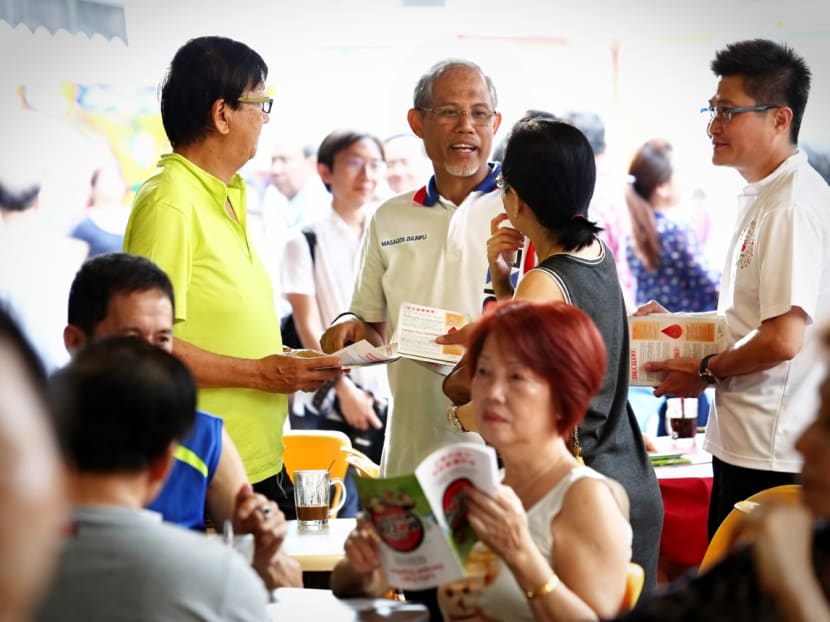 Environment and Water Resources Minister Masagos Zulkifli at Tampines West, distributing pamphlets about Zika. Photo: Nuria Ling