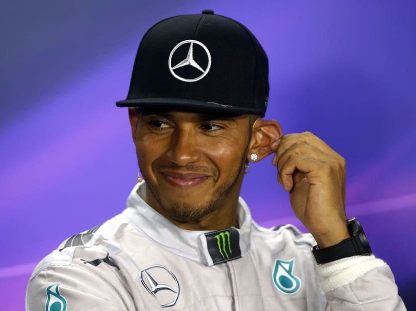 Winner Mercedes Formula One driver Lewis Hamilton of Britain smiles as he answers questions during a news conference after the Singapore F1 Grand Prix. Photo: Reuters