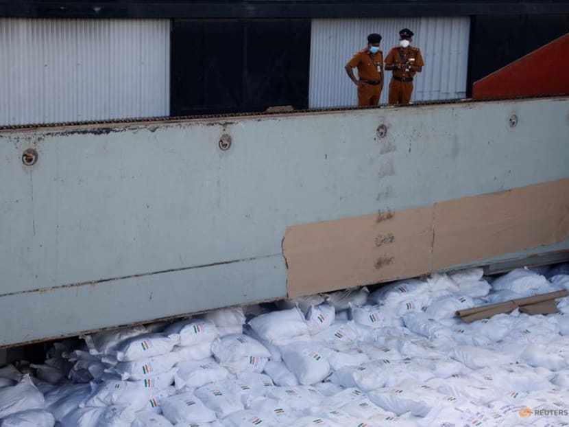 Members of security personnel stand on a cargo ship carrying essential supplies of rice, milk and some critically needed medicines from India, amid Sri Lanka's economic crisis, at a port in Colombo, Sri Lanka, May 22, 2022. 