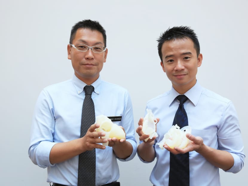 (Left to Right) Dr Nakao Masakazu, Consultant, Cardiothoracic Surgery Service, KKH and Dr Chen Ching Kit, Consultant, Cardiology Service, KKH, posing for a photo while holding the 3D Printed Heart Models. Photo: Koh Mui Fong/TODAY