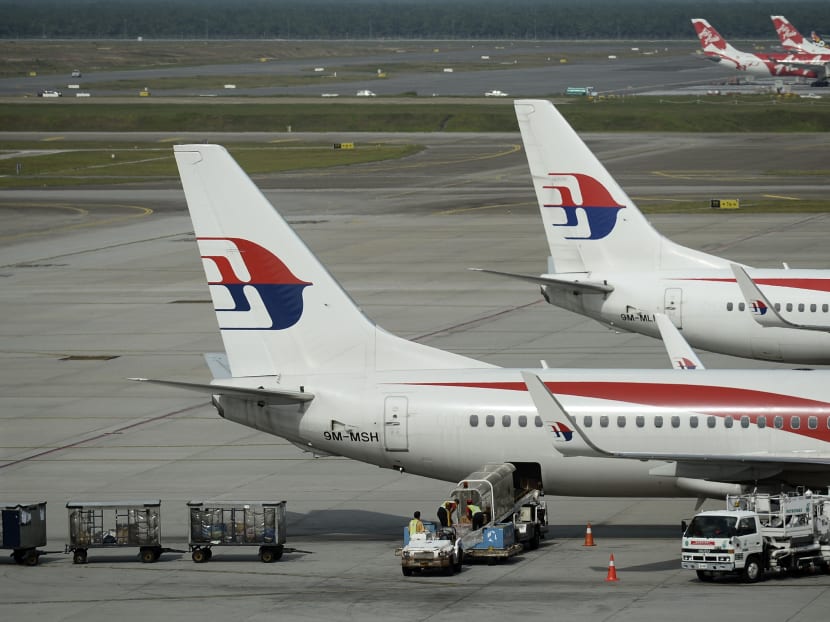 Malaysian Airlines ground crew loads cargo into a Malaysia Airline plane taxied on the tarmac of Kuala Lumpur International Airport. Photo: AP