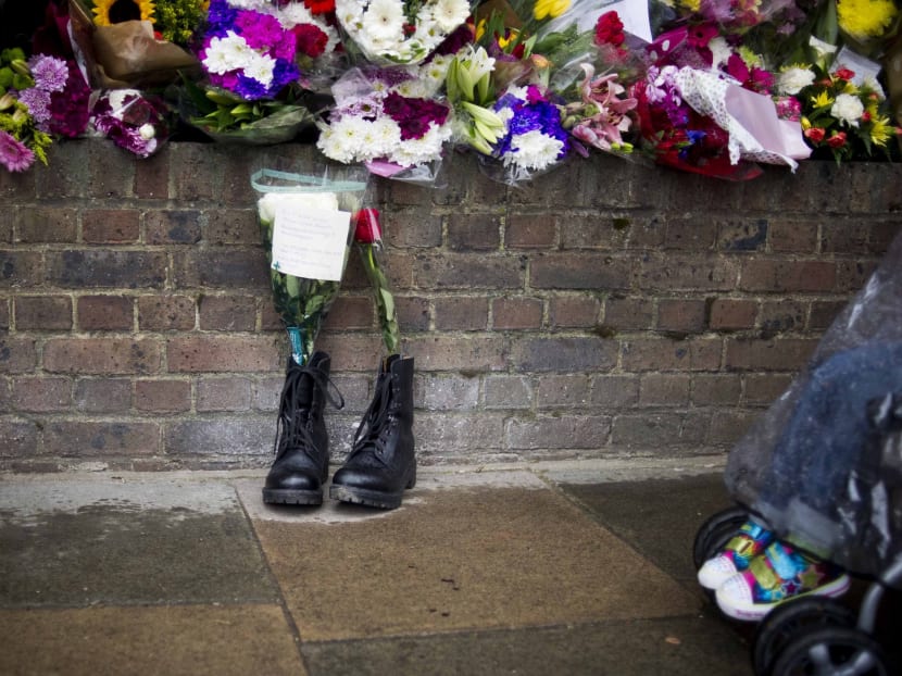 In this Friday, May 24, 2013 file photo, military boots are laid in tribute outside the Woolwich Barracks, in London, in response to the bloody attack on Wednesday when a British soldier was killed in the nearby street. Photo: AP