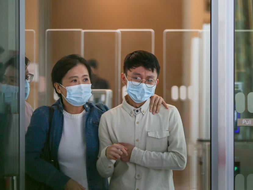 Nicholas Kwang Zhen Xing (right) leaving the State Courts on Feb 9, 2022. 