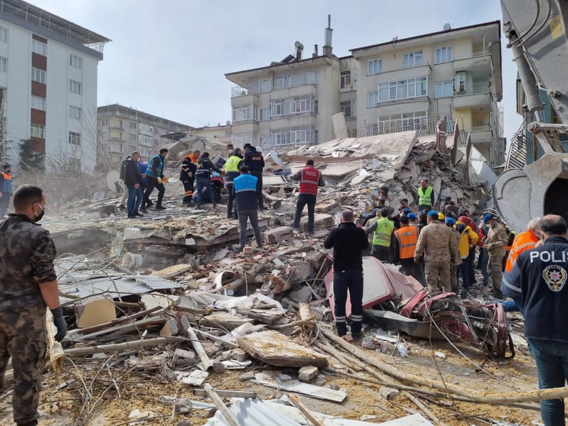 Rescuers carry on search operations among the rubble of collapsed buildings in the Yesilyurt district of Malatya on February 27, 2023 after a 5.6 magnitude earthquake hit eastern Turkiye.