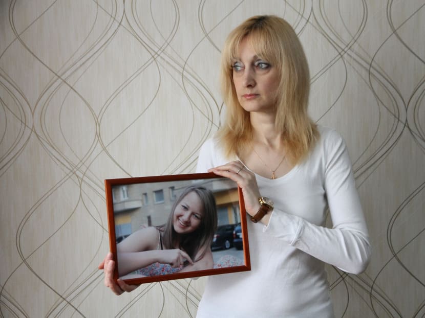 A picture taken on April 2, 2016 shows Yelena Sablina holding a photo of her late daughter Alina at her flat in Yekaterinburg. Photo: AFP