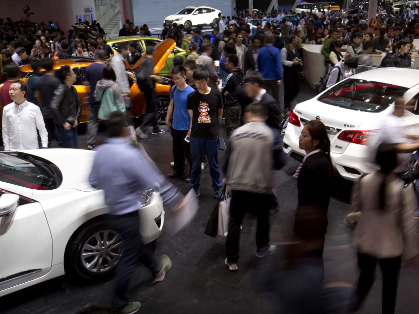 Visitors walk through a display of cars by automaker Nissan at the Beijing International Automotive Exhibition in Beijing on April 27, 2016. The auto show, which opened to the public on Wednesday, continues through May 4. Photo: AP