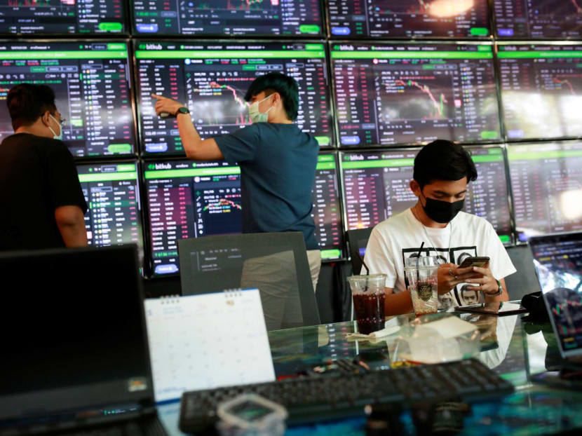 People pass their time at a cafe which has dozens of screens showing the latest trends and prices on various cryptocurrencies for their crypto investors' customers in Nakhon Ratchasima, Thailand on Jan 21, 2022. People pass their time at a cafe which has dozens of screens showing the latest trends and prices on various cryptocurrencies for their crypto investors' customers in Nakhon Ratchasima, Thailand on Jan 21, 2022.