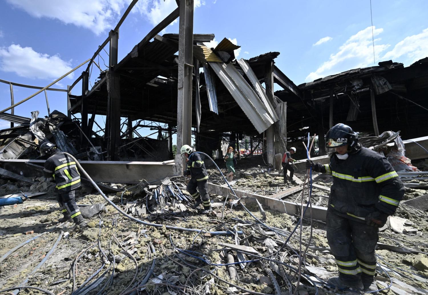 Rescuers clear rubbles of the Amstor mall in Kremenchuk, on June 28, 2022, one day after it was hit by a Russian missile strike according to Ukrainian authorities.