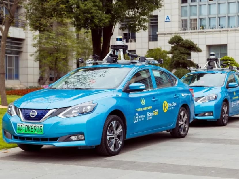 WeRide RoboTaxi service uses blue Nissan electric cars with cameras, GPS locating devices and other sensors attached to their tops.