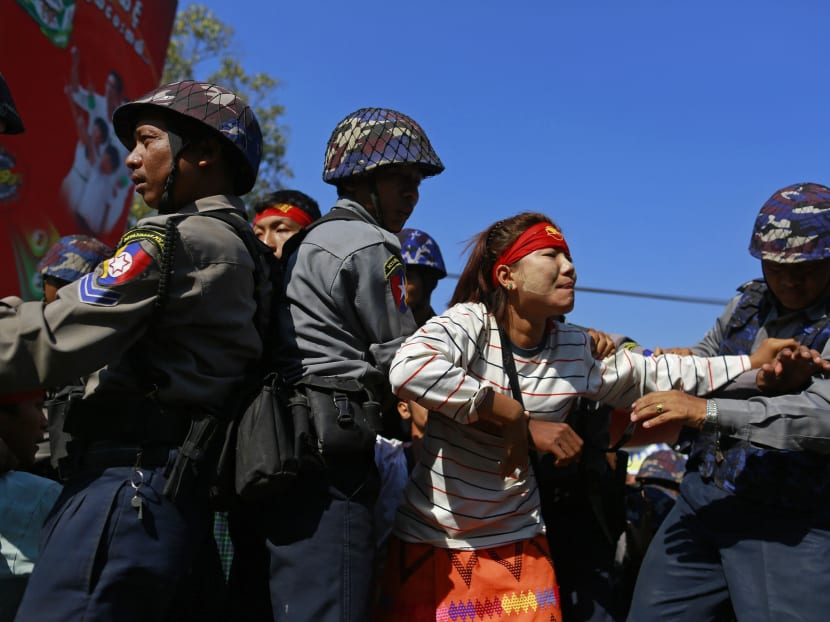 Police restrain student Ei Thinzar Maung during a protest against an education bill in Letpadan, Bago division. Photo: Reuters