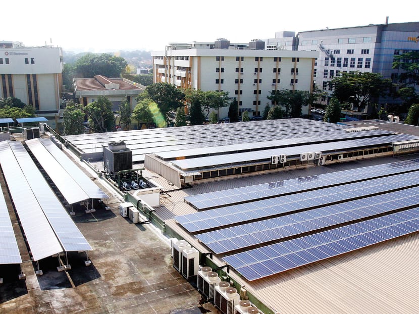Solar panels at the top of a building at Ang Mo Kio Industrial Park. SolarPVExchange aims to tackle the high upfront costs of setting up a solar PV system. Today File Photo
