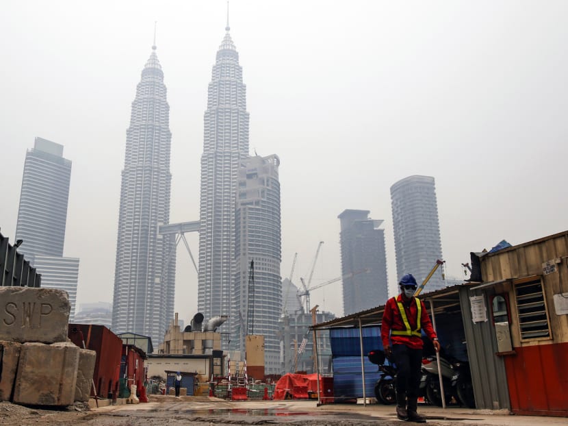 Petronas Twin Towers shrouded with haze in Kuala Lumpur on Wednesday. Ten companies are under investigation to see if they are all responsible. Photo: AP