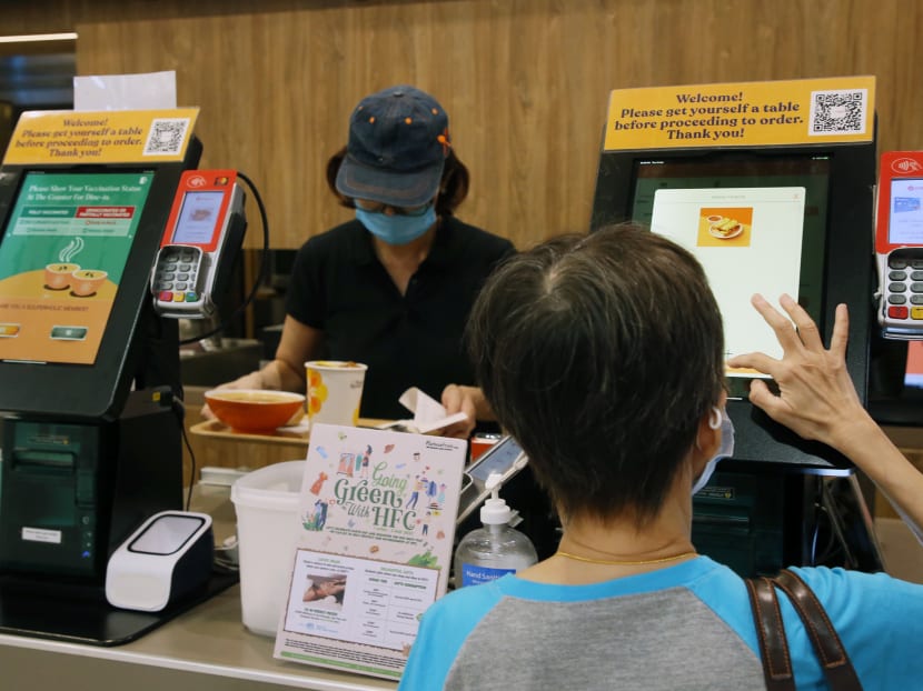 A customer making an order from The Soup Spoon's self-ordering kiosk.