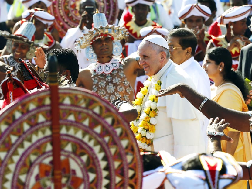 Pope Francis being greeted by traditional dancers as he arrived at Colombo airport yesterday. Photo: REUTERS