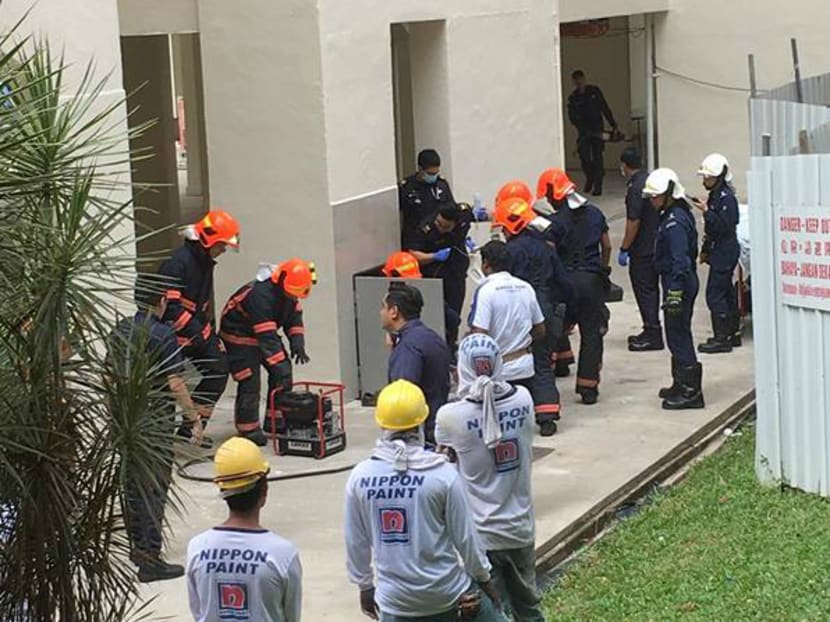 SCDF personnel extracting the victim from the rubbish chute at Blk 8 Jalan Rumah Tinggi. Photo: Advocatus Safety Consultants/Facebook
