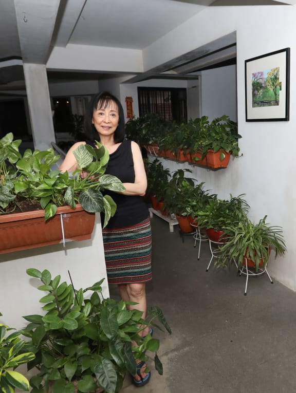 Ms Mary Aw, who lined the corridor outside her Anchorvale Crescent flat with plants and paintings.