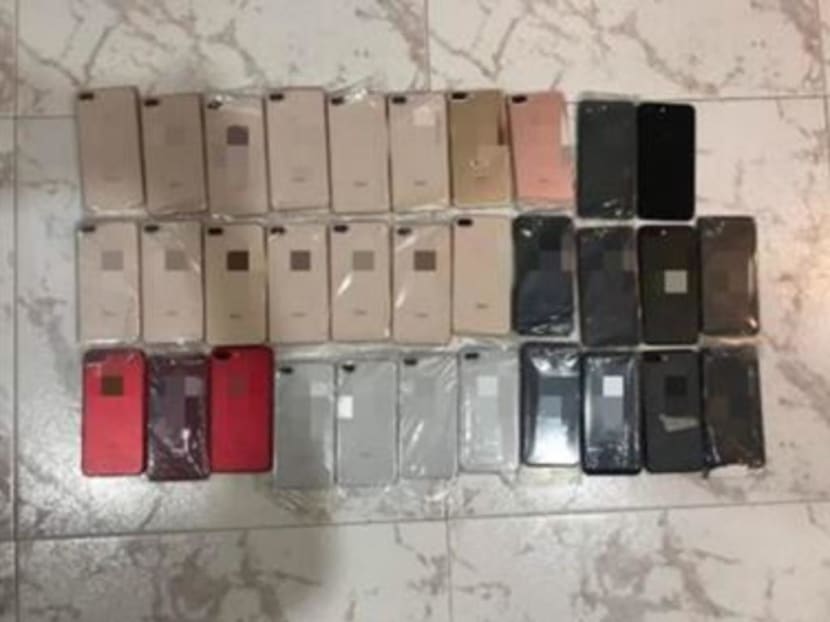 Police seized 65 mobile phones and almost S$6,000 in cash from logistics manager Ng Shu Kian.
