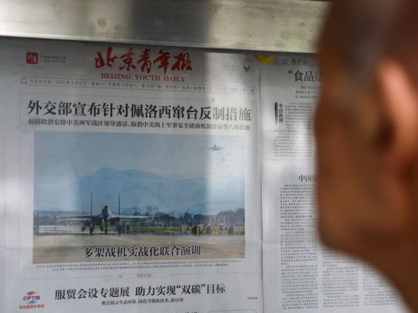 FILE PHOTO: A man reads a newspaper report with an image of military exercises near Taiwan by the Chinese People's Liberation Army's (PLA) Eastern Theatre Command on the front-page, at a newspaper stand in Beijing, China, August 8, 2022. REUTERS/Tingshu Wang FILE PHOTO: A man reads a newspaper report with an image of military exercises near Taiwan by the Chinese People's Liberation Army's (PLA) Eastern Theatre Command on the front-page, at a newspaper stand in Beijing, China, August 8, 2022. REUTERS/Tingshu Wang