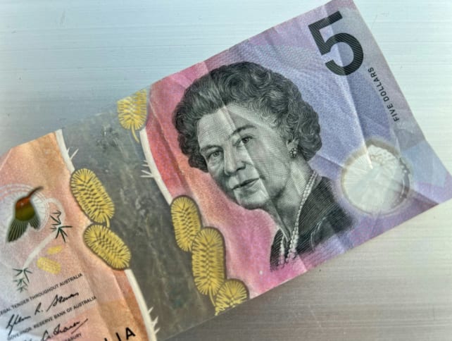 This photo illustration taken in Hong Kong on February 2, 2023 shows the Australian $5 banknote. 